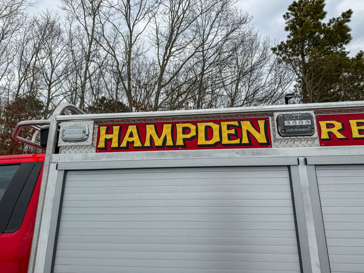 Rear upper body signage reading HAMPDEN RESCUE above compartment doors.